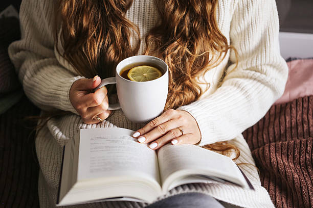 Person reading a book in warm evening light without screens